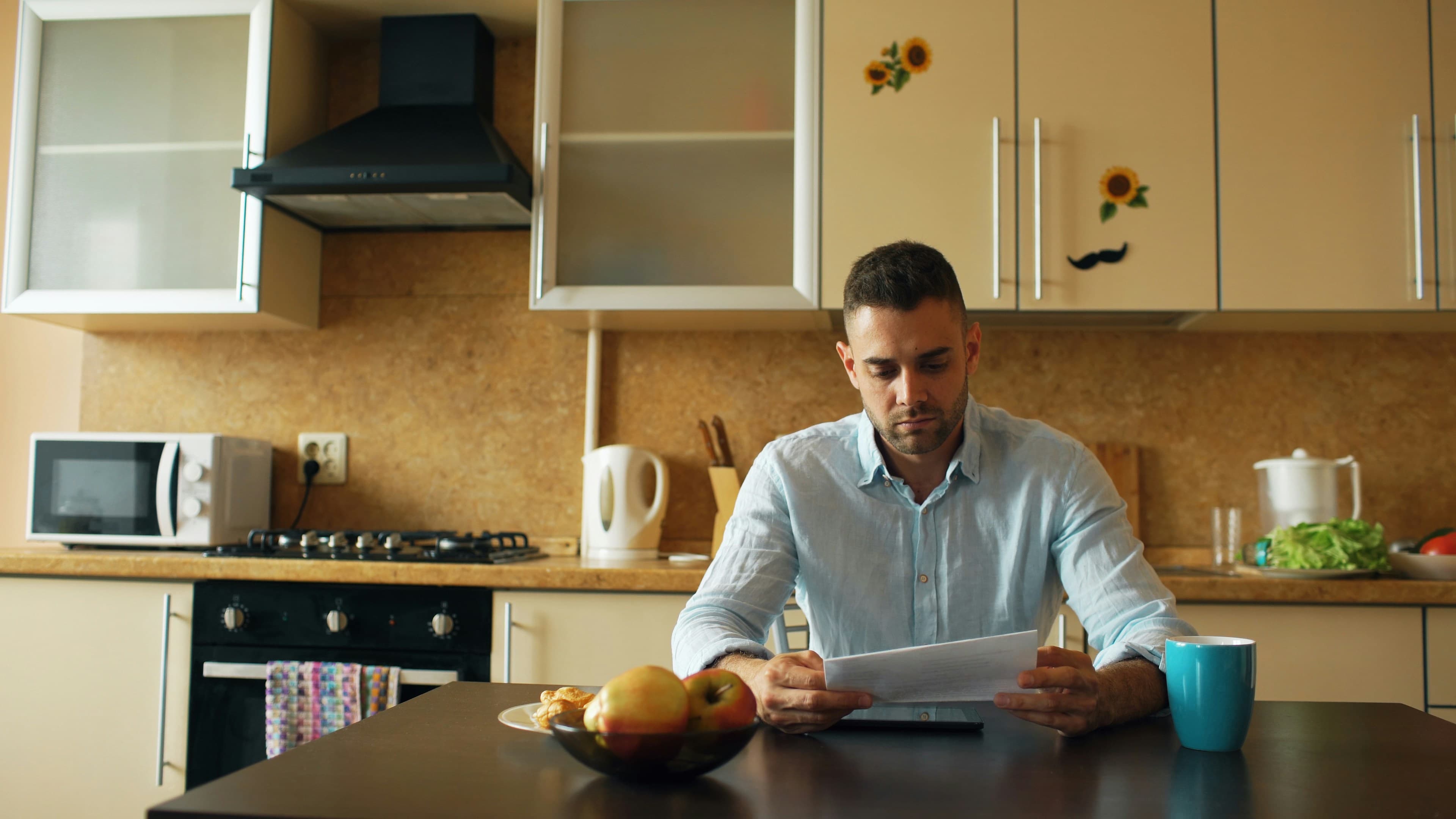 Person reviewing a printed bill at home